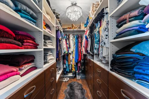 Dreamy closet space with custom shelves, built-ins and drawers.