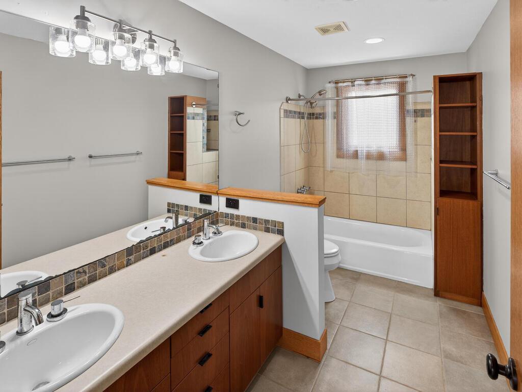 Full bathroom with dual vanity sinks and tub shower combination 34290 Lanesboro Ct North Branch MN 55056 USA-064-032-062-MLS_Size.jpg