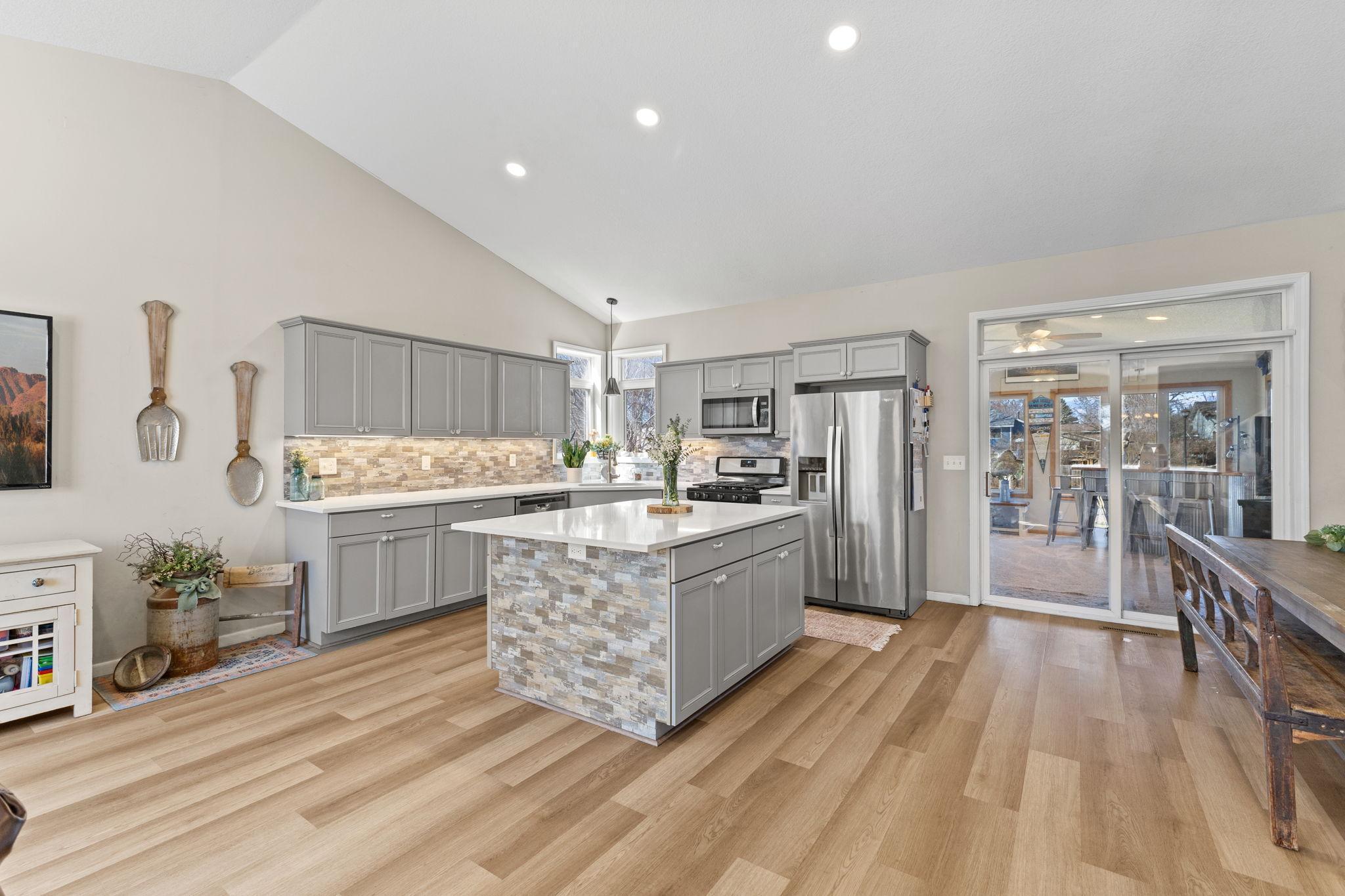 The center island offers additional casual seating while the informal dining area is perfect for hosting larger gatherings.