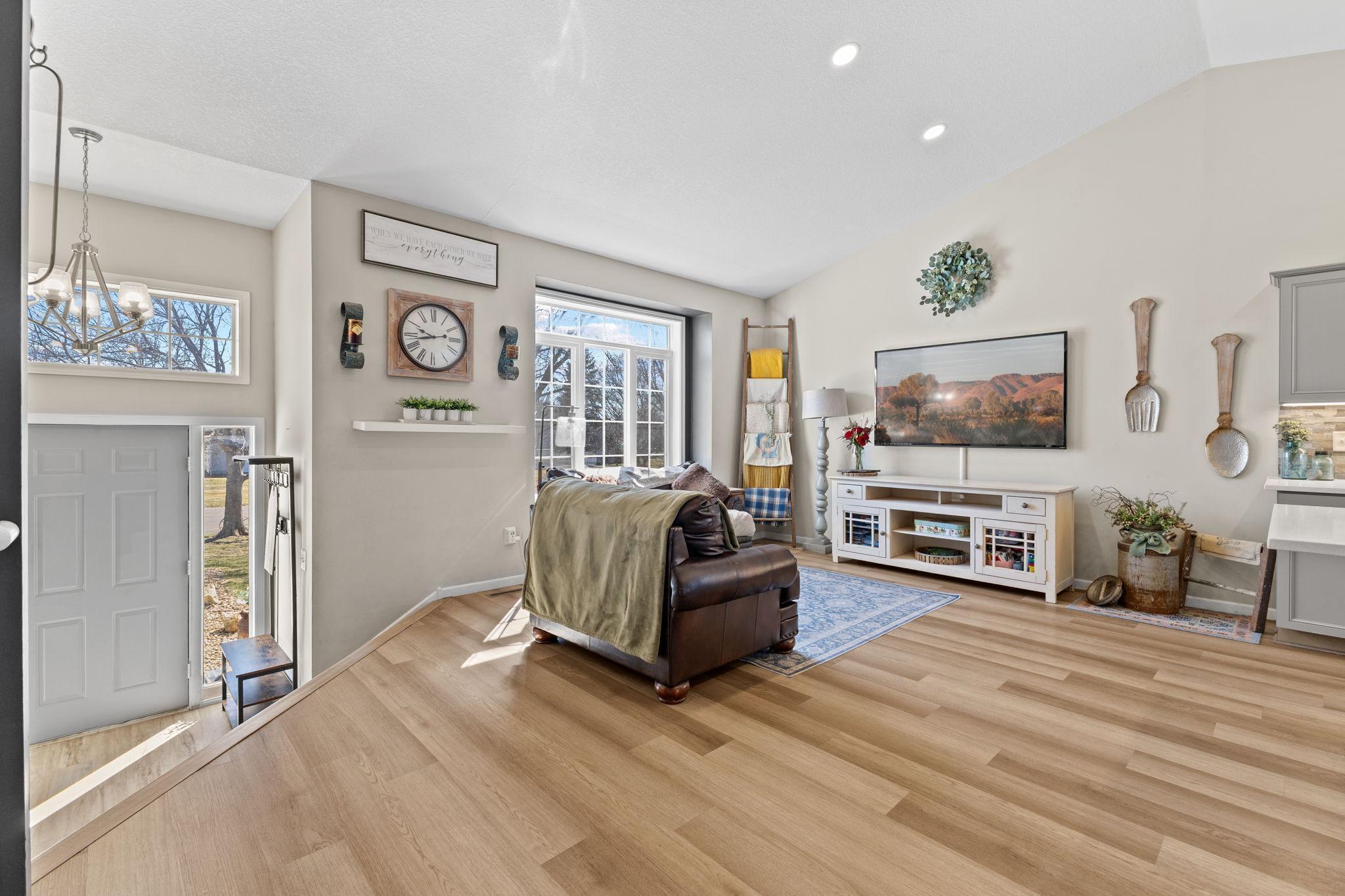 The living room is flooded with abundant natural light pouring in through its large windows!