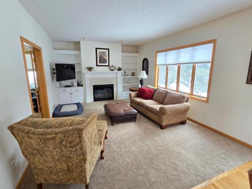 MF living room with re-done gas fireplace and lots of natural light!