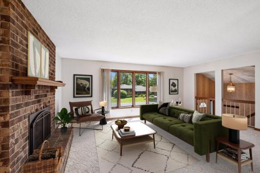 This virtually staged photo showcases the beauty of the brick gas fireplace.