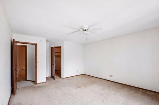 This view of the primary bedroom shows access to the huge closet and upper level bathroom.
