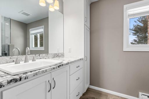 Enjoy your private ensuite with Granite Countertop, New Tile and Cabinetry plus Walk-in Shower.