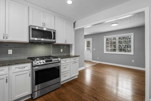 Gleaming, refinished original Hardwood Flooring unites the Kitchen and Dining Space with Backyard Views.