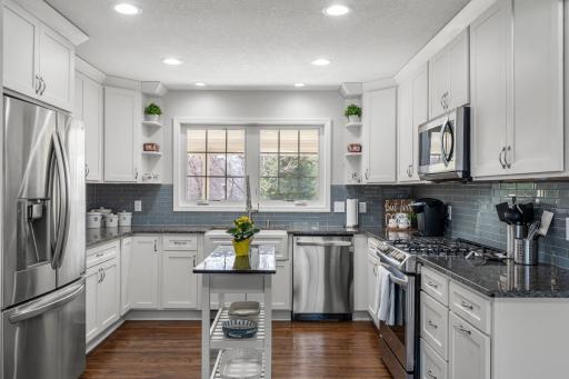 Stunning 2018 kitchen renovationâshaker-style cabinetry & granite countertops! Small island is free standing and not included.