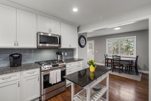 Nice White Cabinetry with Crown Molding Trim provides a Full Custom Look! Gas Stove, Microwave and Refrigerator all included.