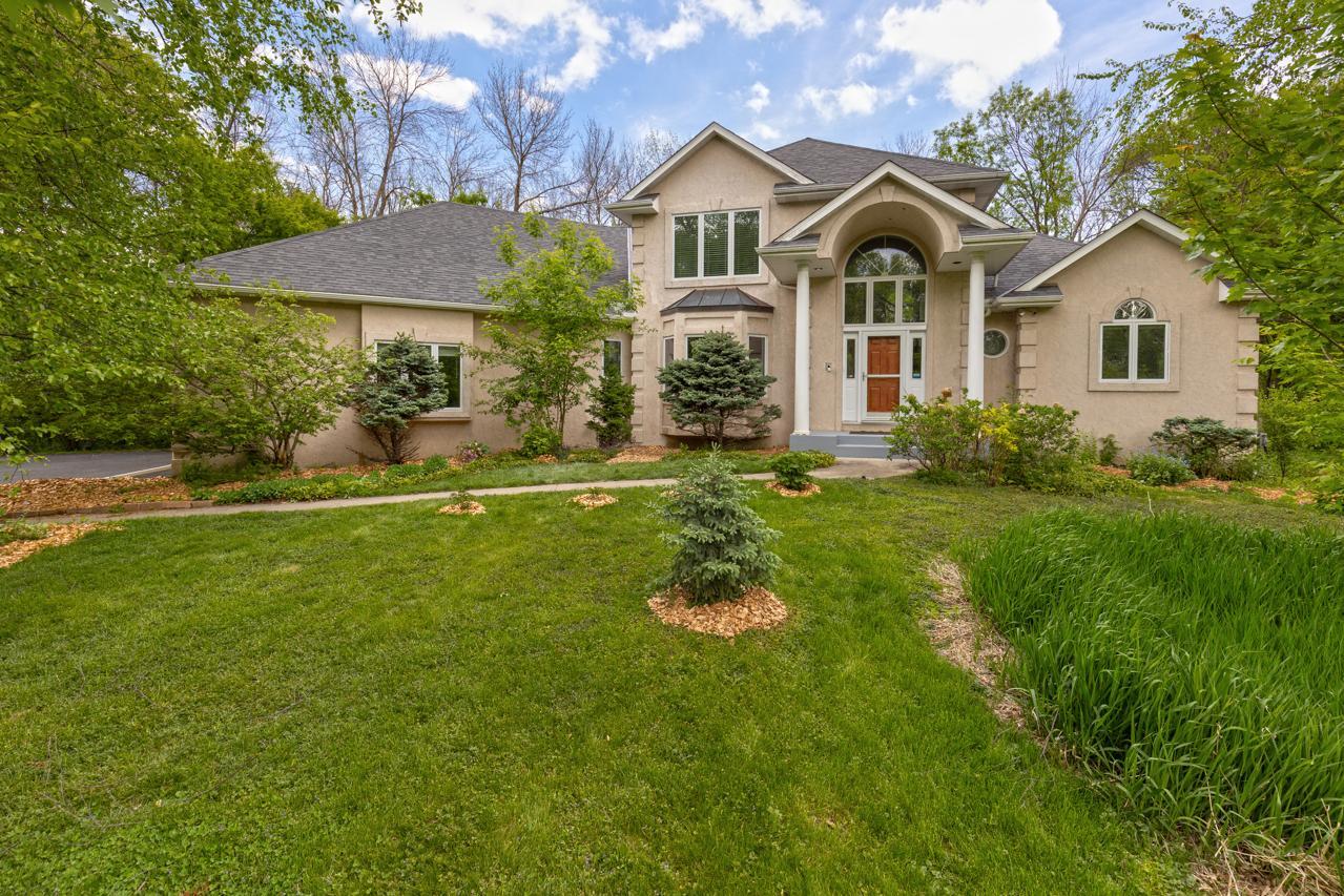 Crafted by renowned luxury builder John Kraemer & Sons, this exceptional executive residence is set on one of the most remarkable one-acre properties located within the prestigious Minnetonka Public Schools district.