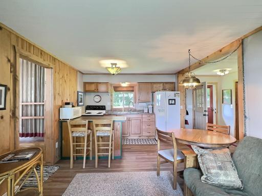 The open-concept kitchen and dining area offers a cozy, cabin-inspired ambiance with natural wood accents.