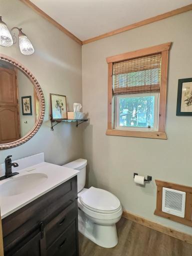 This updated bathroom blends rustic charm with modern comfort - featuring a sleek vanity with dark cabinetry.