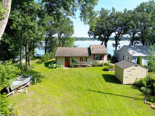 Charming lakefront cabin nestled on the serene shores of Big Elk Lake, enjoy a level lot leading to the shoreline.