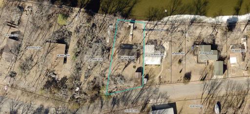 Aerial image of the property - the level lot with mature trees gently slopes to your private dock and shoreline.