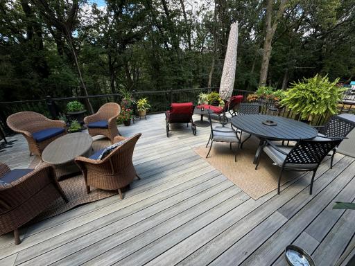 The view to the rear is no less magnetic. A newer composite deck, breathtaking in scale, invites everyday use, weather permitting, and enables a range of entertainment configurations and cookery. A stairway leads to yet another deck and patio.