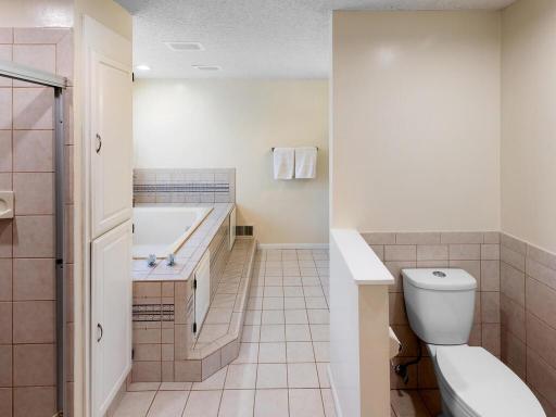 Newer toilet offers a degree of privacy as it is tucked nest to a half wall.