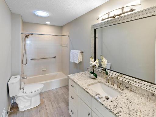 Ensuite Bath for bedroom # 2 has umany updates: vanity, granite countertop, undermount sink, mirror, satin nickel hardware, flooring and toilet.