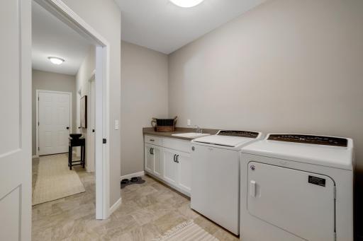 The primary bedroom functions as its own quiet oasis on the main level, complete with a spa-style stone shower and a walk-in closet.