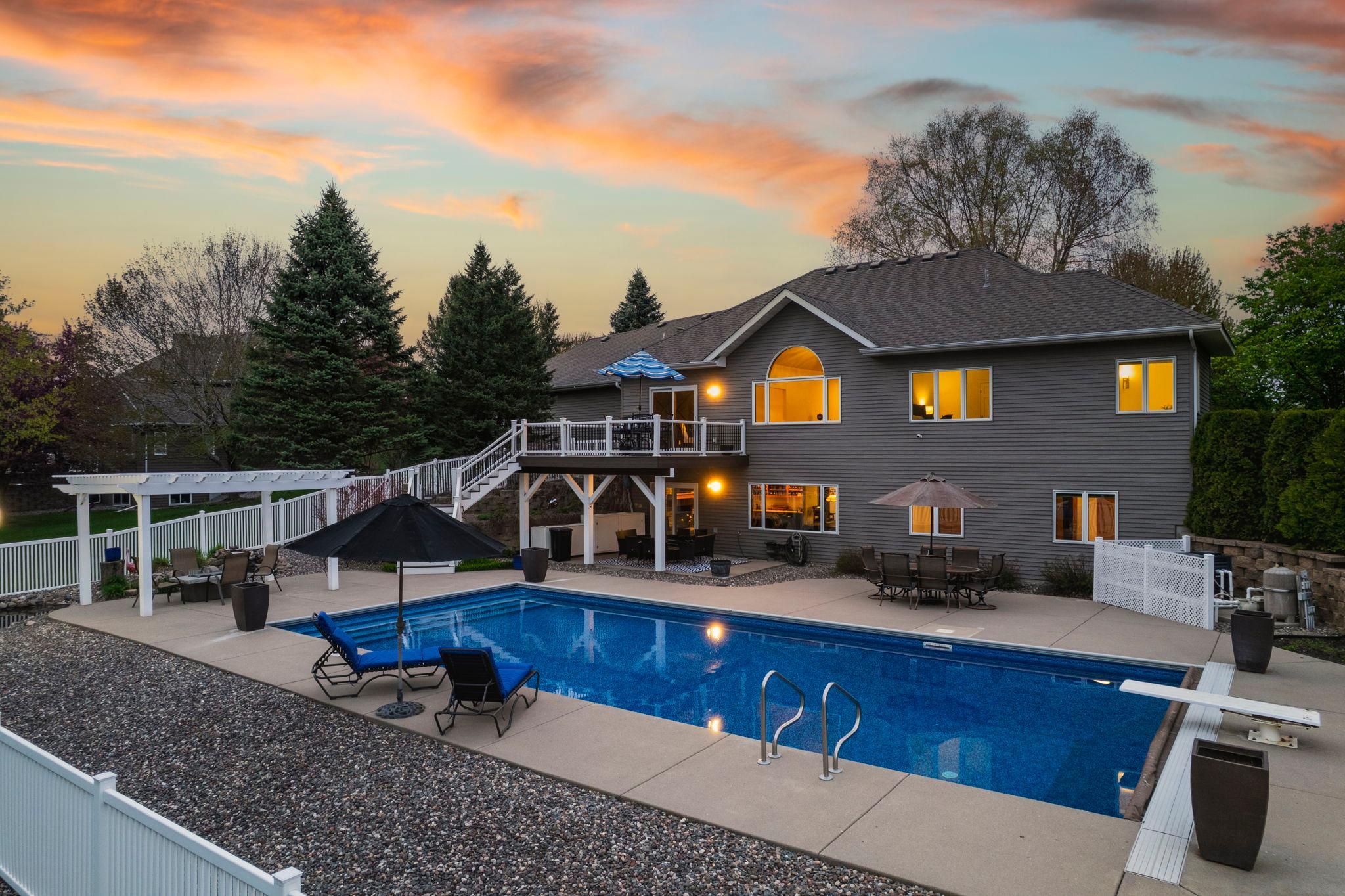 The backyard is an entertainer's dream with a heated in-ground pool, expansive deck, and spacious patio perfect for relaxing or hosting all summer long.