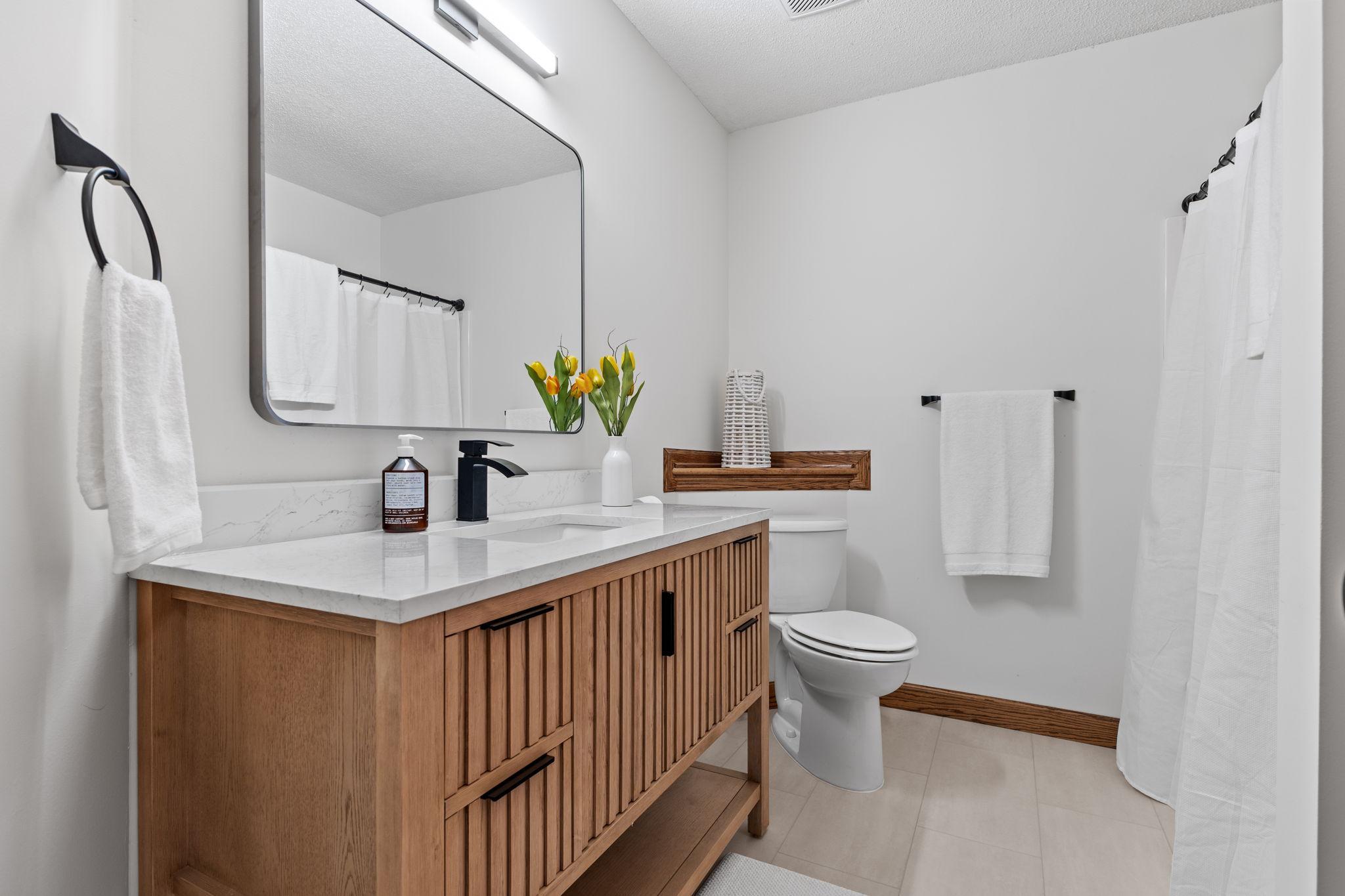 Tasteful and convenient lower level full bathroom.