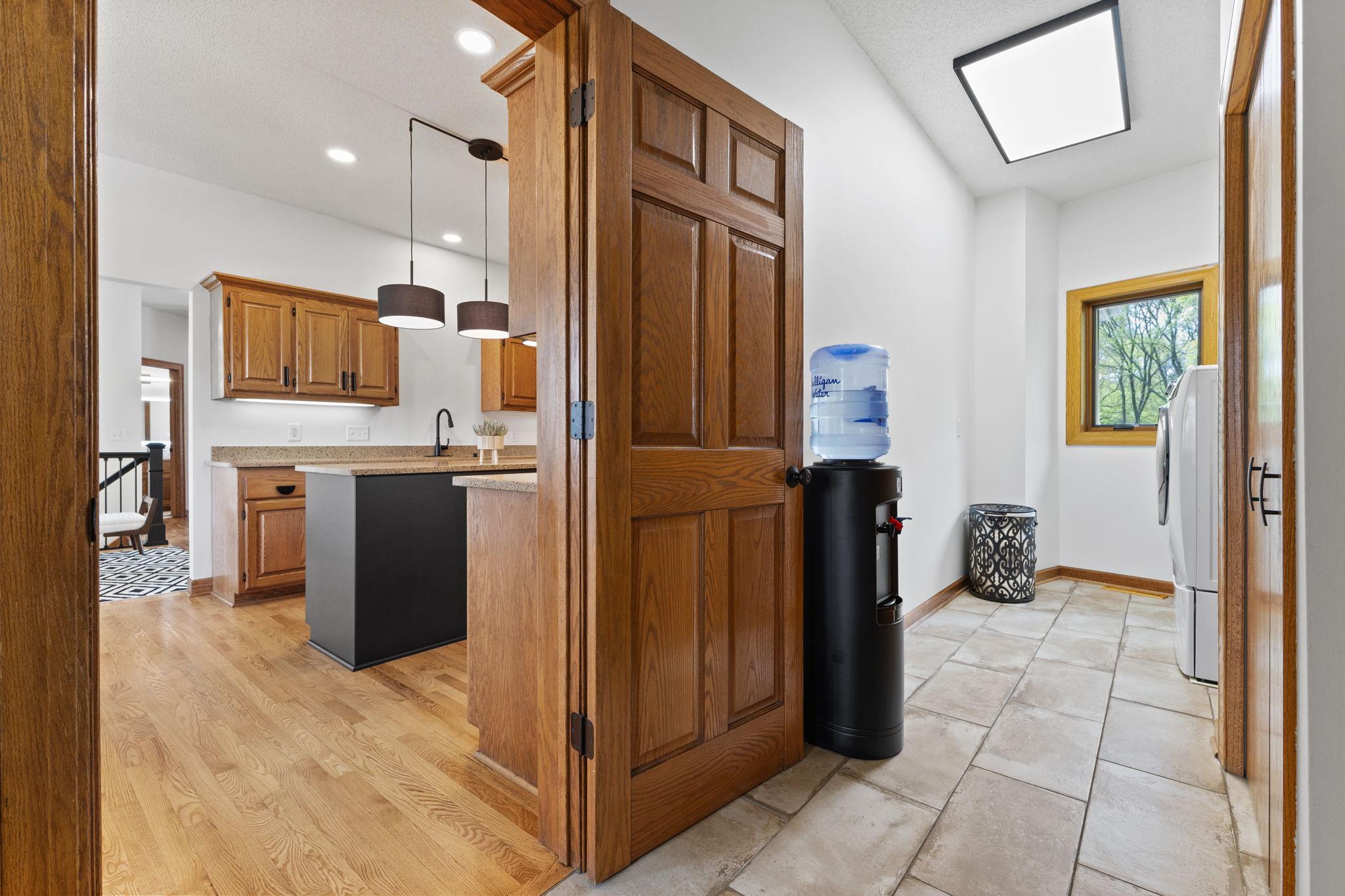 Just off the kitchen, you’ll find the laundry room and secondary access from the attached garage.