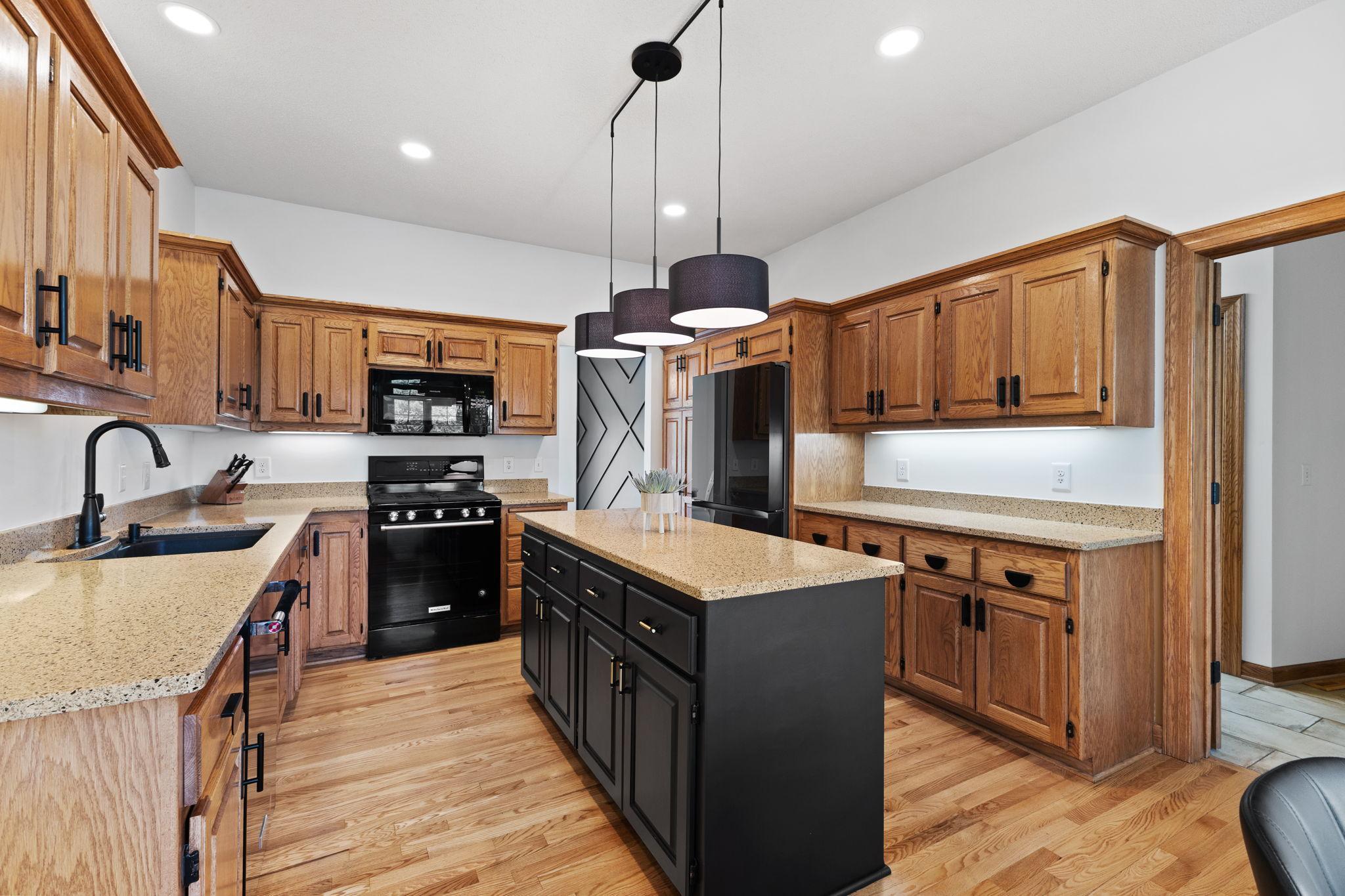 The updated kitchen is a showstopper with granite countertops, a center island, and modern lighting and hardware.