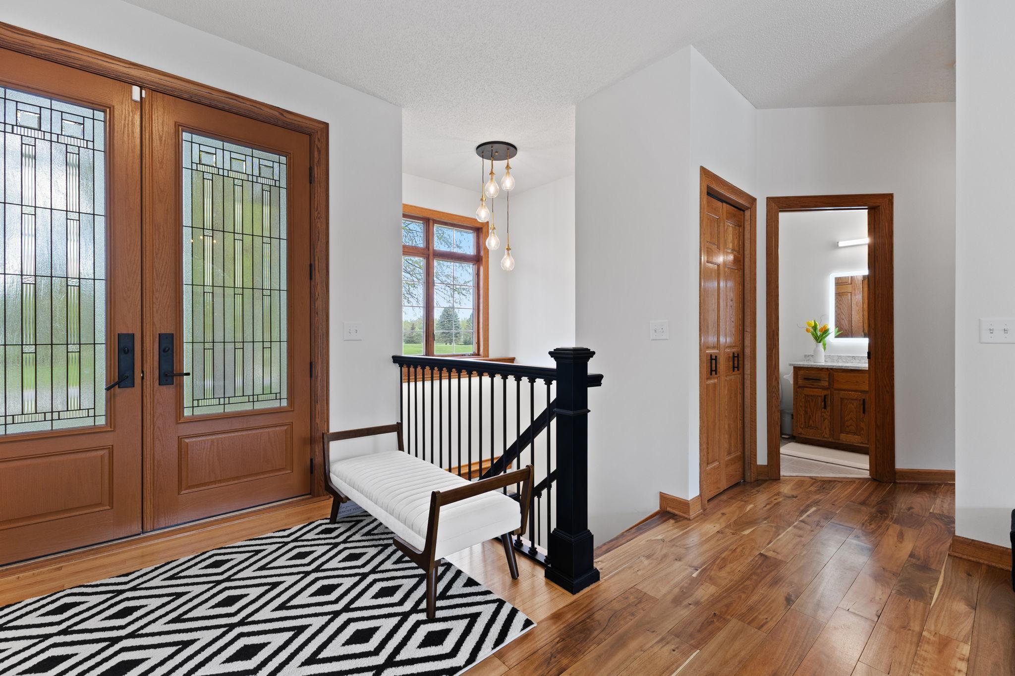 A convenient entry closet and thoughtfully located main level bathroom add everyday functionality and ease.