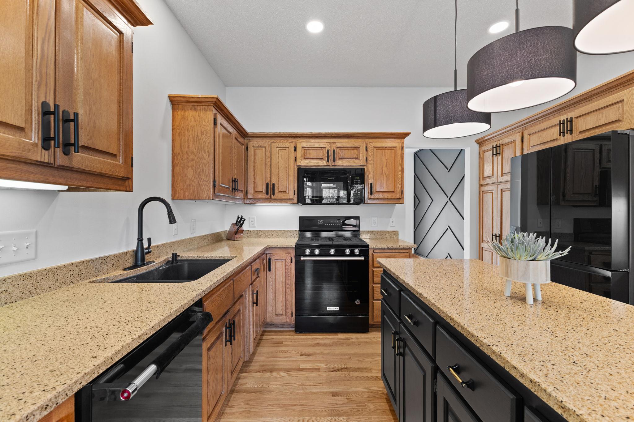 A closer look showcasing the beautiful cabinetry and sleek granite countertops.