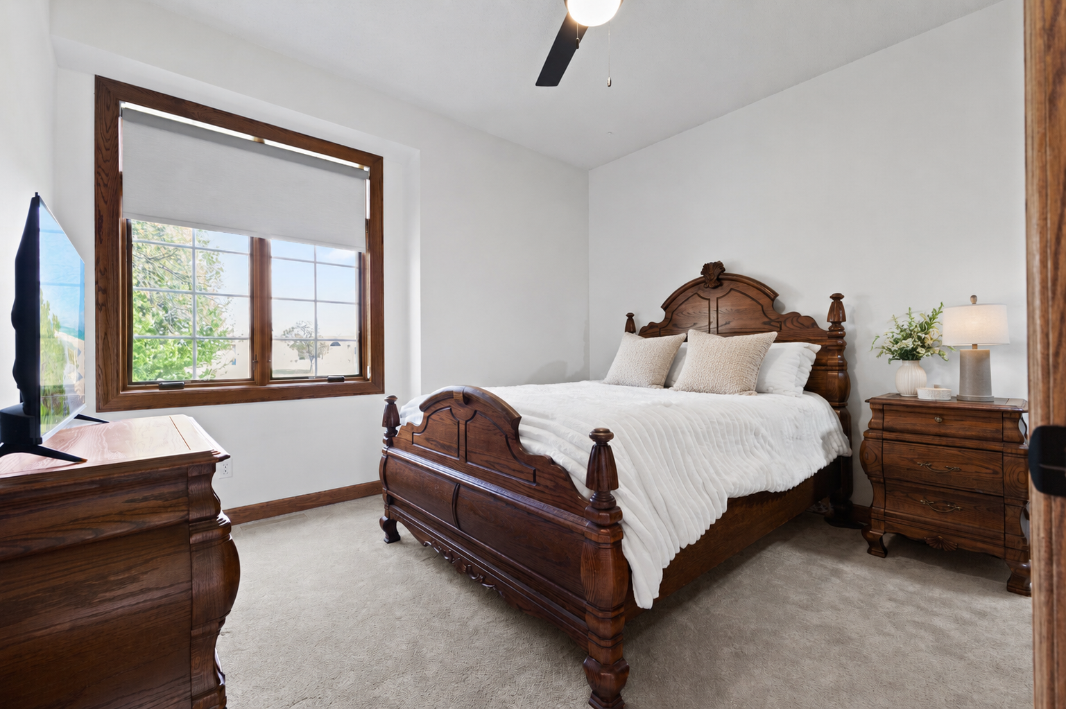 The second main level bedroom is conveniently located near the primary bedroom, ideal for keeping loved ones close by.
