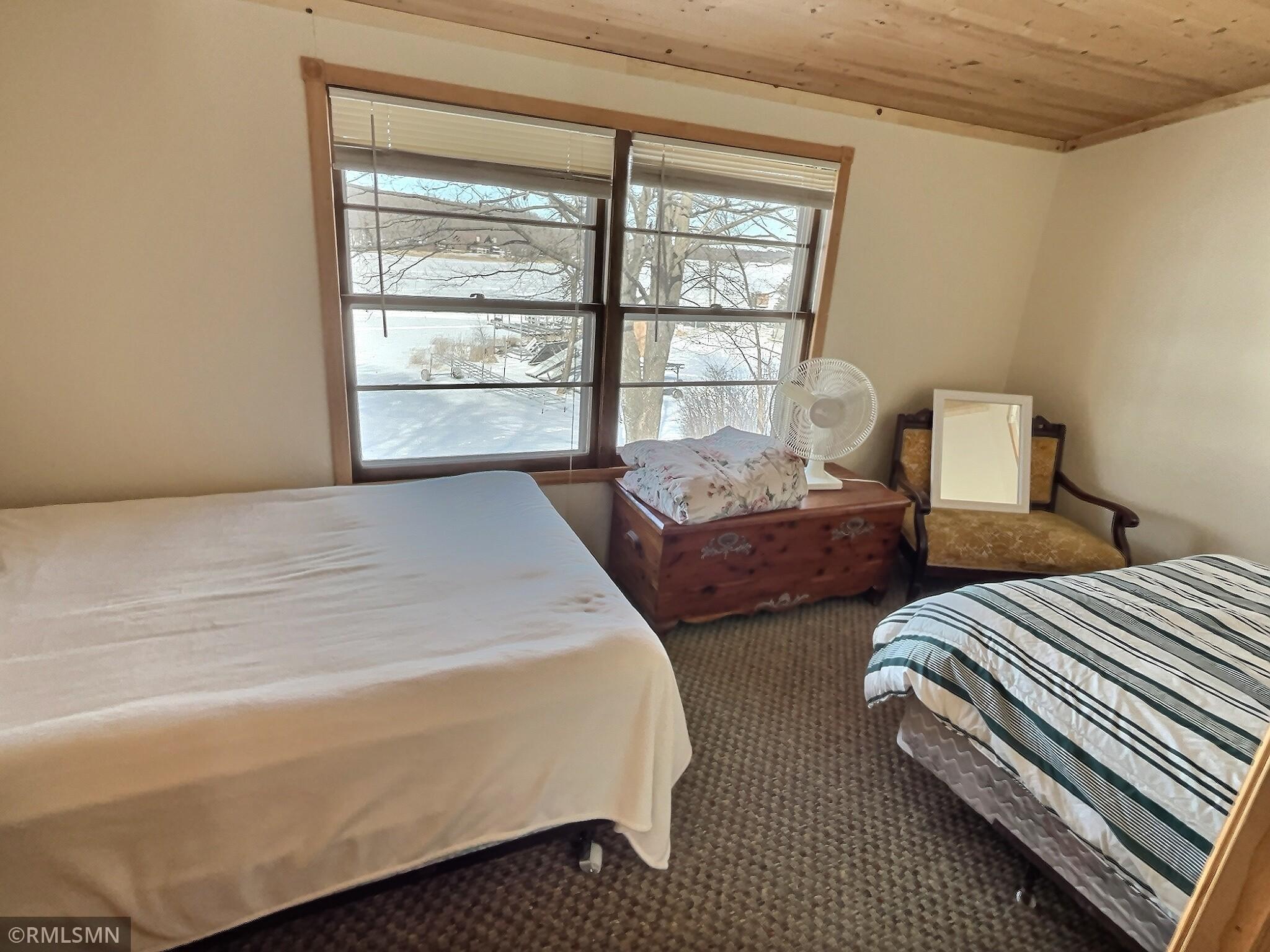 Lake side bedroom with ample room for two beds.