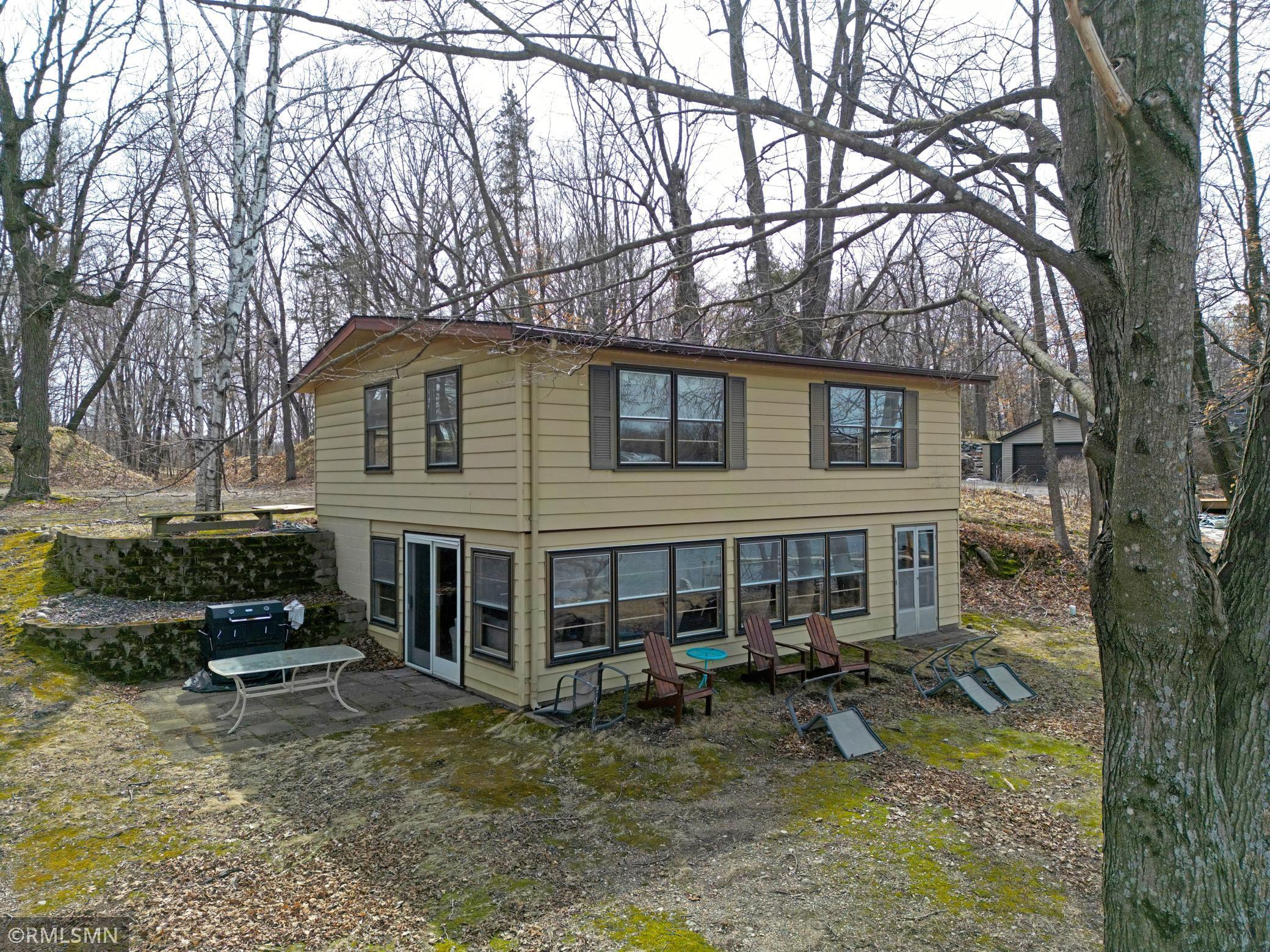 This shot from the north highlights the sliding door which walks out to patio made of pavers and is a great place to have your grill station.