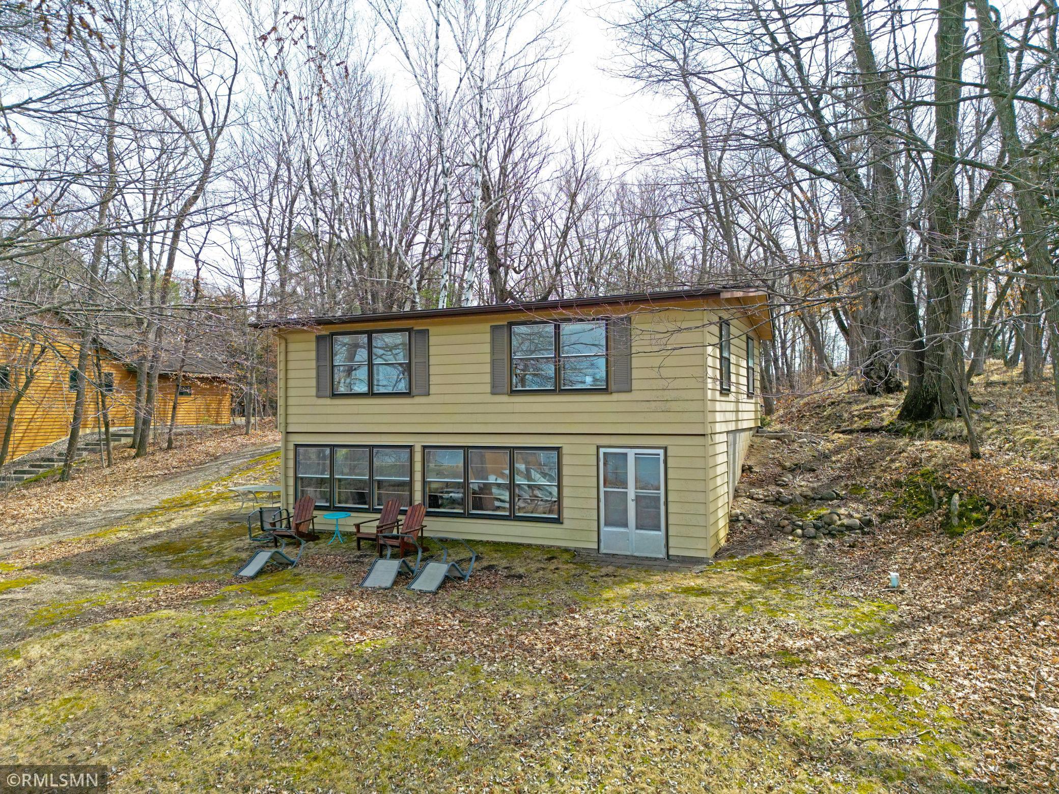 The lake side view of the home shows the door on the bottom right to access the storage area.