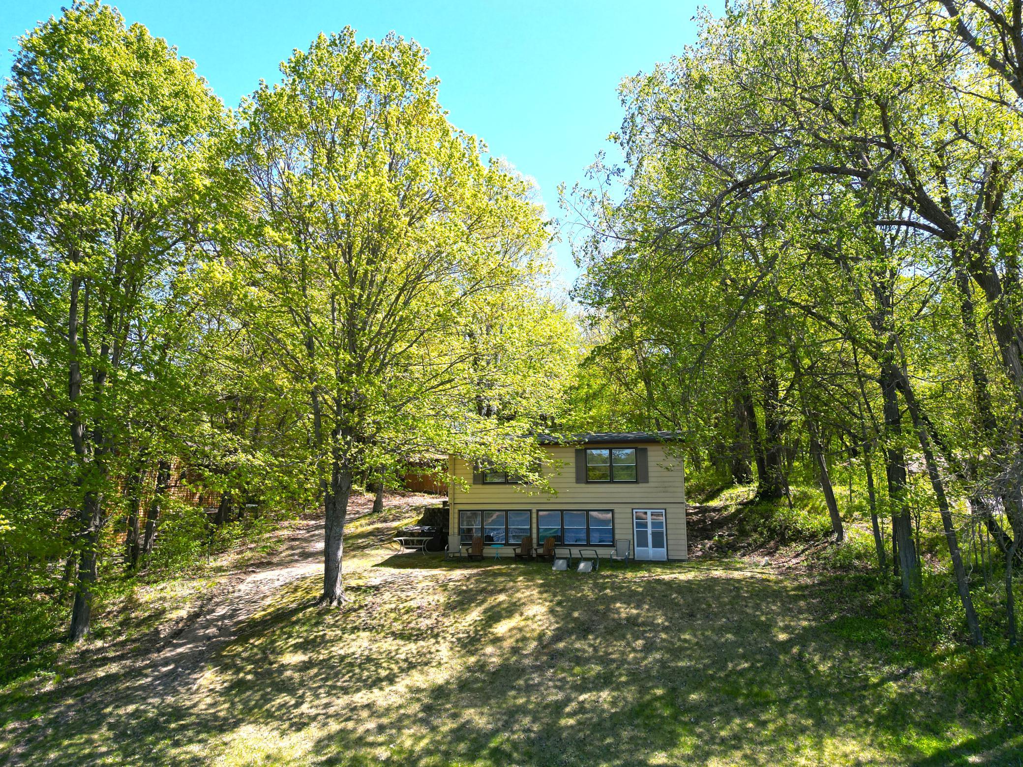 The lake side view of the home shows the door on the bottom right to access the storage area.