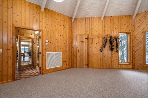 Wooden door leads into bathroom and sauna.