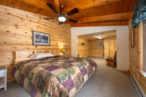 First bedroom on main floor. Seating area leading into attached bathroom.