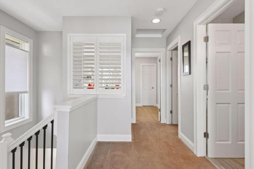 Step upstairs to the upper level, where bedrooms, a home office nook, and additional bathrooms provide comfort and convenience.
