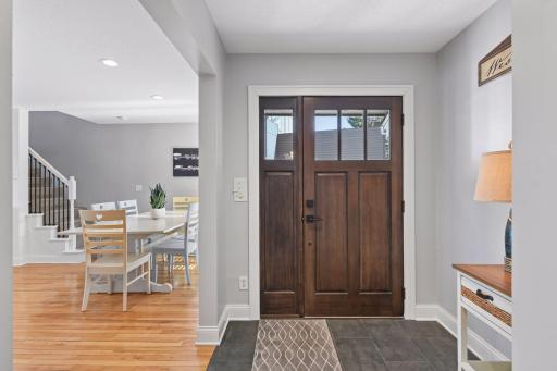 Step into a welcoming entry that flows into a practical mudroom with access to the garage and backyard, while the charming dining space greets you just inside the home.