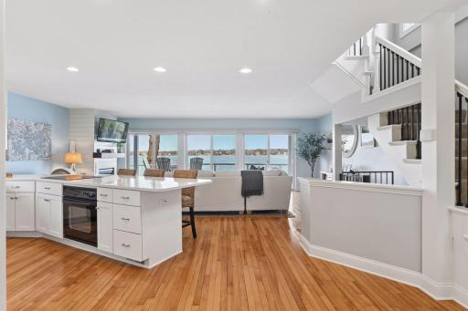 An open floor plan filled with natural light captures beautiful lake views. The main level features hardwood floors.