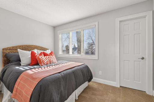 1 of 3 upper level bedrooms with a walk-in closet.