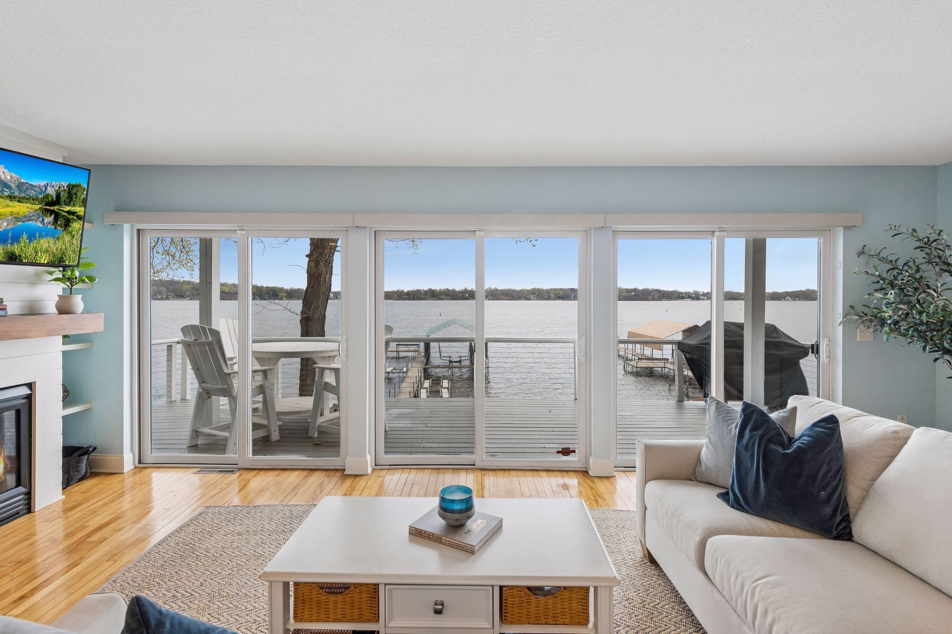 Expansive patio doors on every level frame the breathtaking lake views.