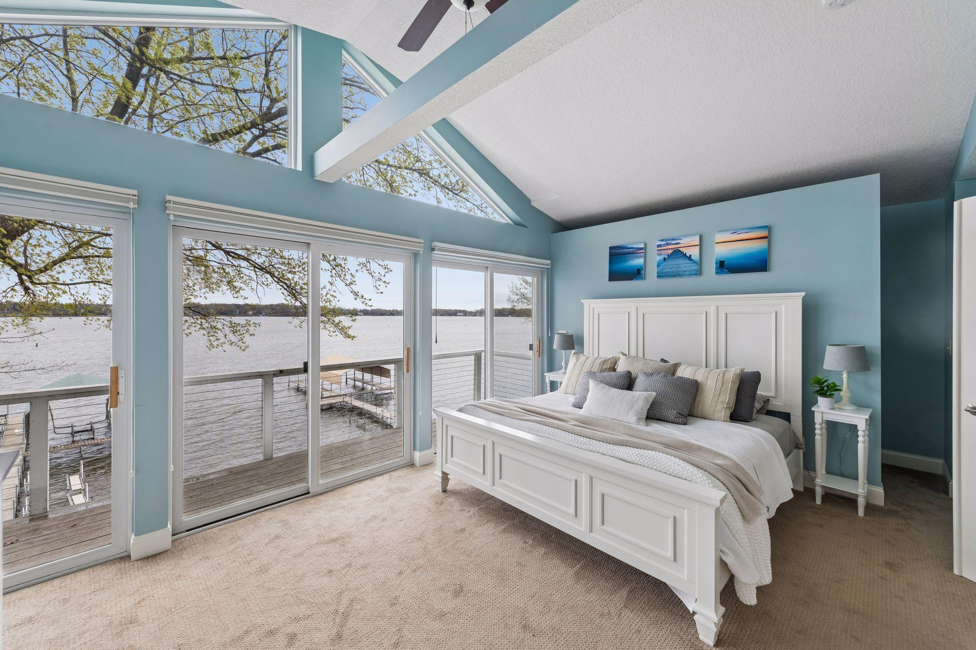 Stunning primary suite with vaulted ceilings, dual closets, and a private balcony deck overlooking the lake.