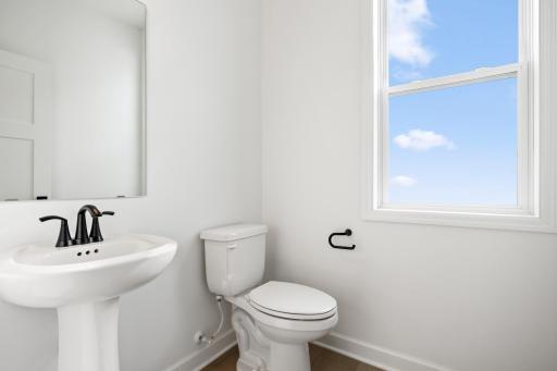 Conveniently placed near the Great Room, the powder room is conveniently trucked away with privacy in mind.