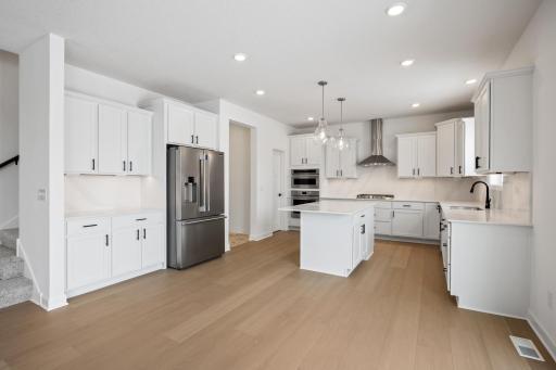 The kitchen has ease-of-access to the mudroom and flows seamlessly into the dining room