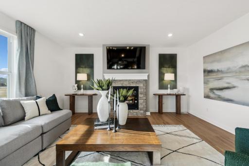 (Photo of decorated model, actual home's finishes will vary) This modern fireplace with natural stone surround is an extraordinary room accent. Enjoy the warmth of this gas fireplace as you relax in your living room.
