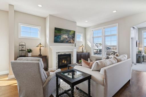 Living space with fireplace that has great lighting as well from the windows. Plenty of room for various seating options.