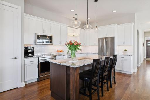 Glorious kitchen that has a center island with a great amount of space with cabinets galore!