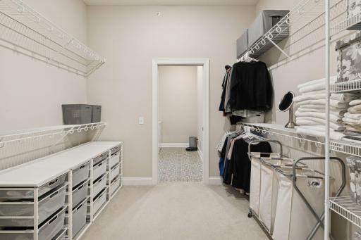 Big primary closet. Plenty of storage and organization options! Walk through from the bathroom and then to your laundry room.