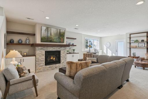 Lower level living space. Beautiful fireplace and area to sit along with host! Even the lower level receives a great amount of sunlight.
