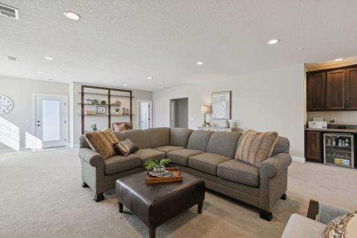 Open space on the lower level which features a beverage fridge that stays with the home!