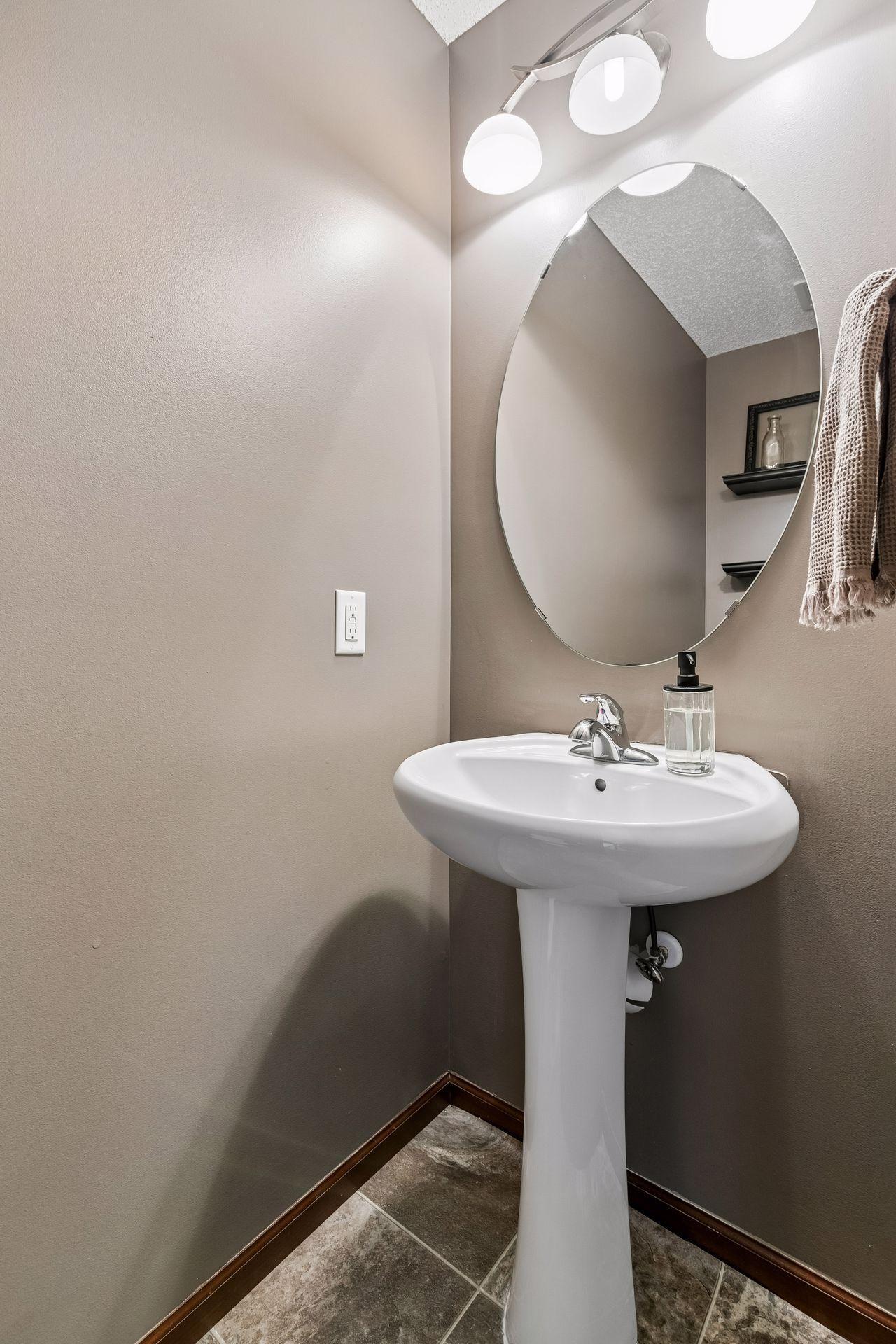 Convenient main-level half bath with updated pedestal sink (new 2026)