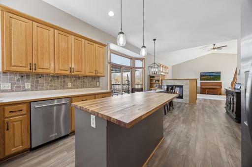 The open feel and high ceilings of the main gathering spaces make the space feel welcoming and inviting. Note the easy transition from kitchen to dining and the outdoor deck area! Great for entertaining!