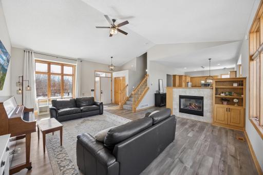 The living room features a gas fireplace to enjoy on the cooler months! The large bank of tall windows on both sides of the home and high ceilings allows for tremendous light.